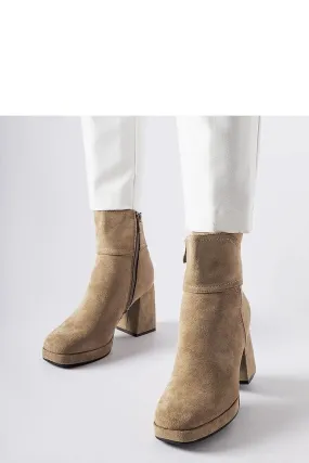Grey boots on a massive post